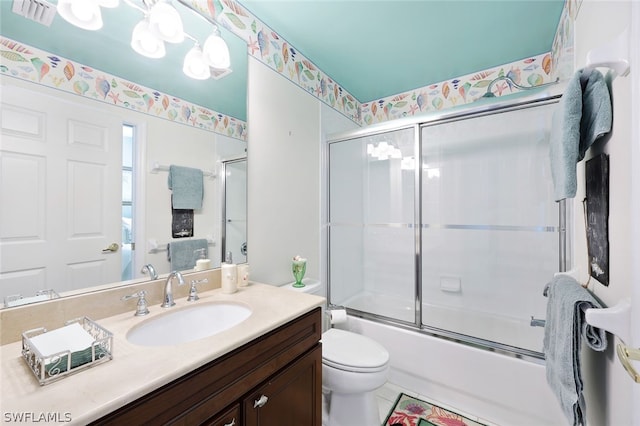 full bathroom featuring visible vents, vanity, toilet, and bath / shower combo with glass door