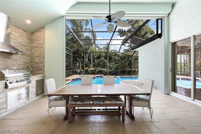 view of patio / terrace with glass enclosure, an outdoor kitchen, a grill, and an outdoor pool