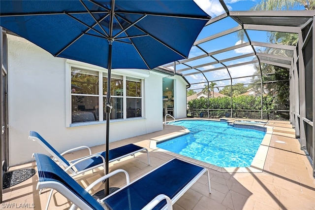 pool with a lanai, a patio, and an in ground hot tub