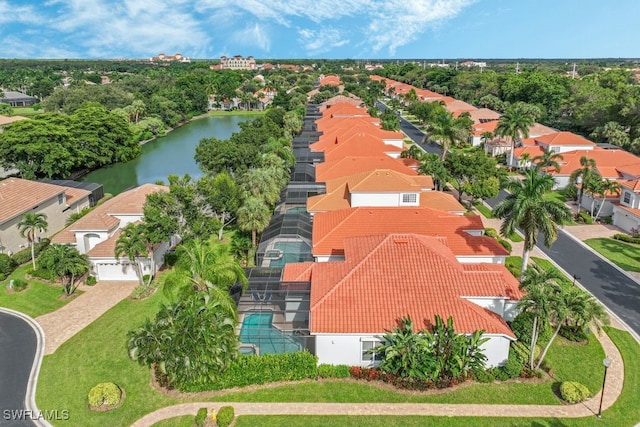 drone / aerial view with a residential view and a water view