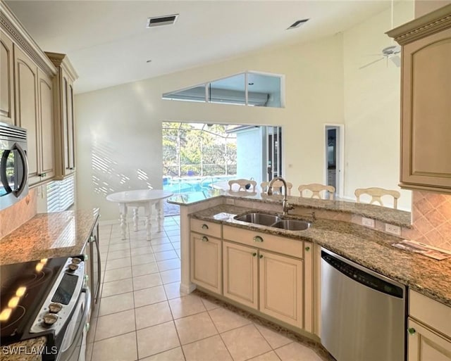 kitchen featuring light tile patterned floors, visible vents, decorative backsplash, appliances with stainless steel finishes, and a sink