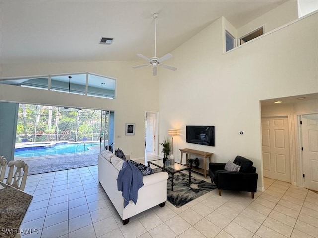 living room featuring vaulted ceiling, visible vents, ceiling fan, and light tile patterned flooring