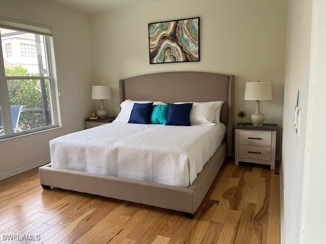 bedroom with light wood-style floors and baseboards