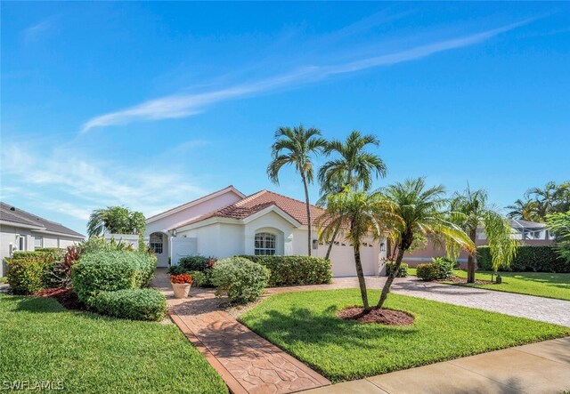 view of front of property featuring a garage and a front lawn