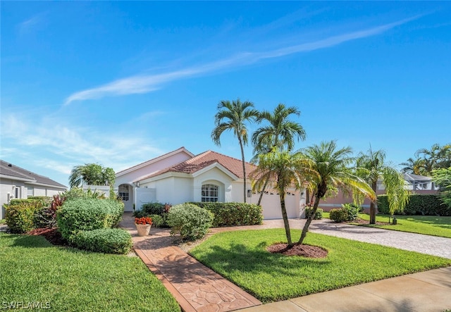 view of front of property featuring a garage and a front yard