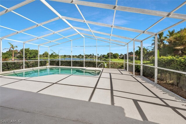 view of pool with glass enclosure and a patio area