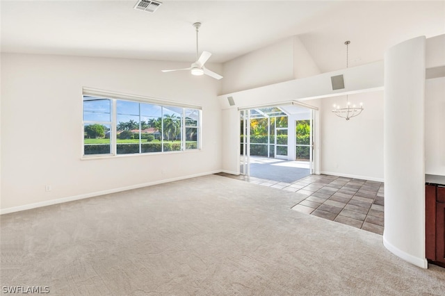 unfurnished living room with carpet, ceiling fan with notable chandelier, and lofted ceiling