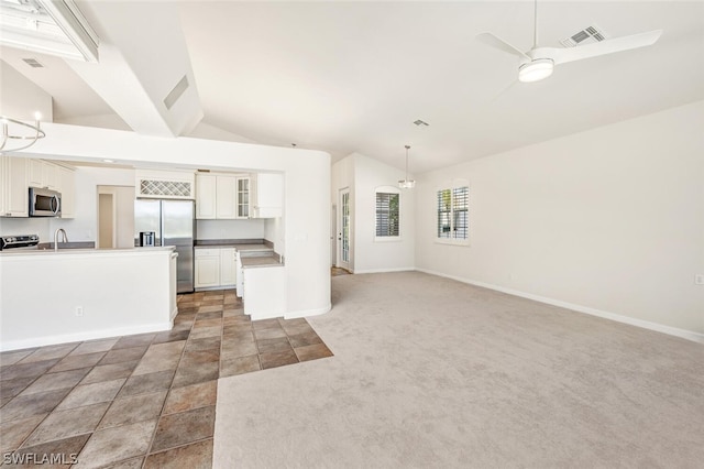 unfurnished living room featuring ceiling fan with notable chandelier, sink, vaulted ceiling, and dark colored carpet