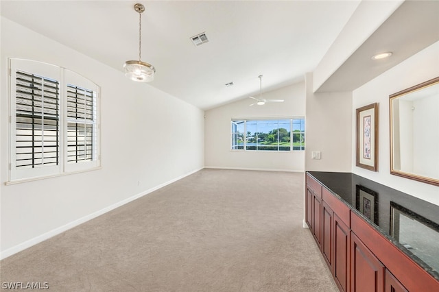 carpeted spare room with lofted ceiling and ceiling fan