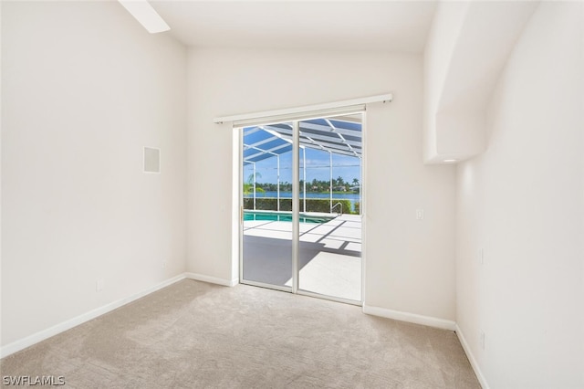 empty room with lofted ceiling and light colored carpet