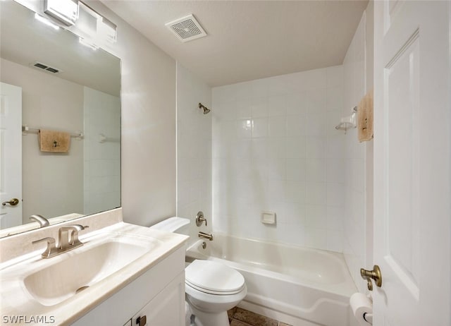 full bathroom with vanity, tiled shower / bath combo, and toilet