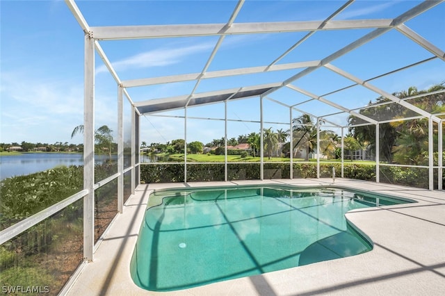 view of swimming pool with a patio area, glass enclosure, and a water view