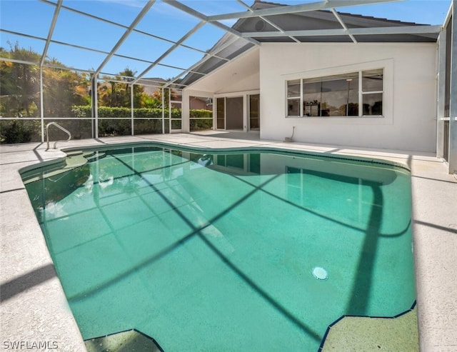 view of pool with a patio and glass enclosure