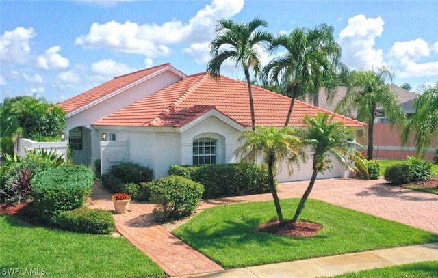 mediterranean / spanish-style home with a front lawn