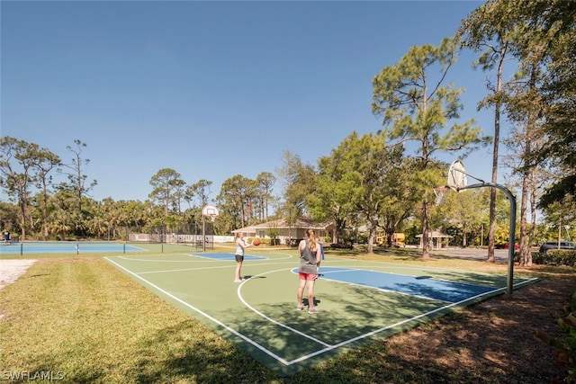 view of basketball court with a lawn