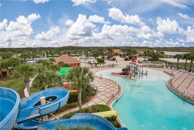 view of pool featuring a playground and a water slide