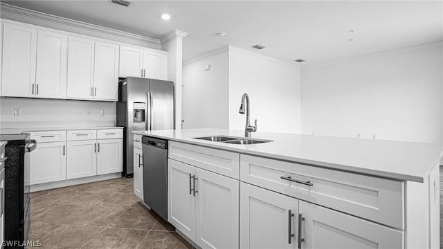 kitchen with appliances with stainless steel finishes, sink, white cabinets, ornamental molding, and tile patterned floors