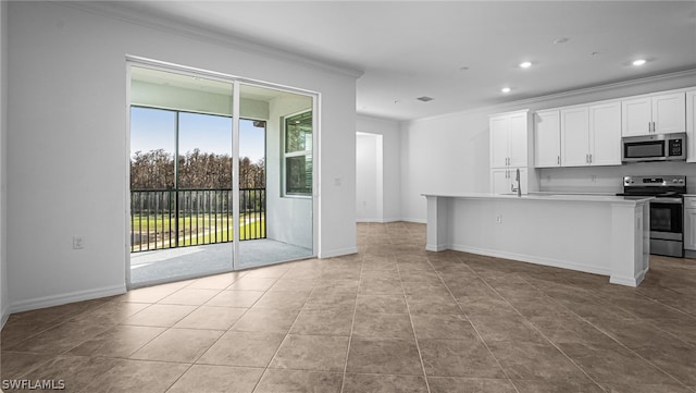 kitchen with sink, a center island with sink, ornamental molding, stainless steel appliances, and white cabinets