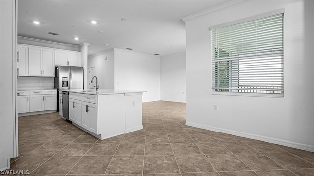 kitchen featuring ornamental molding, dishwasher, a center island with sink, and white cabinets