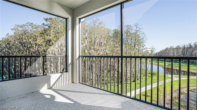 unfurnished sunroom with a water view