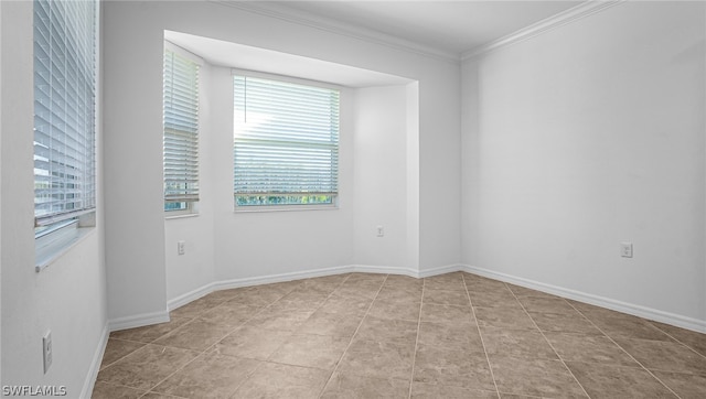 tiled spare room featuring ornamental molding