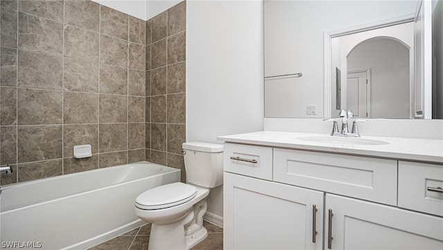 full bathroom with tile patterned flooring, vanity, tiled shower / bath, and toilet