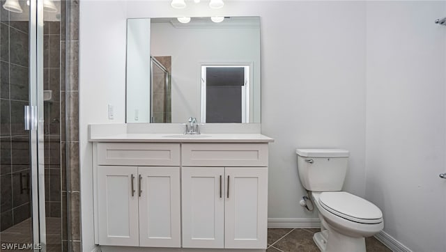 bathroom with walk in shower, vanity, and toilet