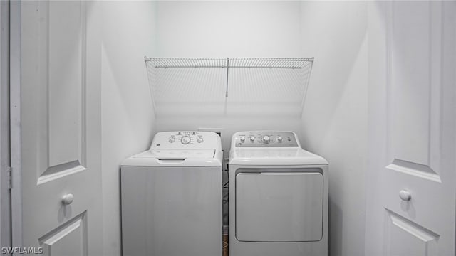 clothes washing area with washer and dryer