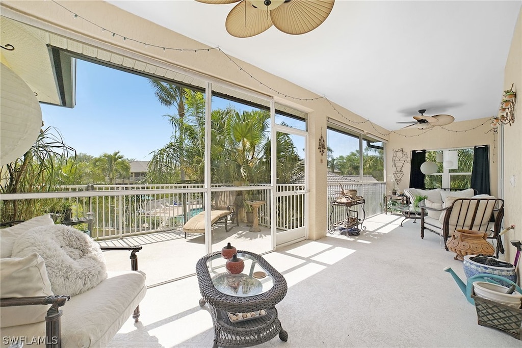 sunroom / solarium featuring ceiling fan