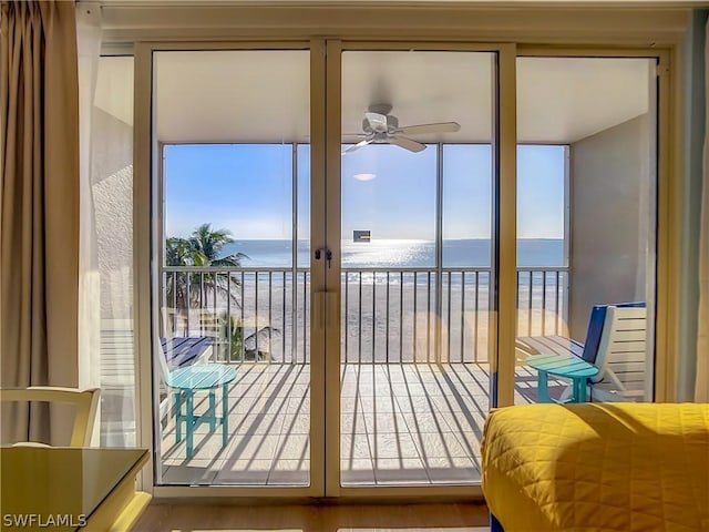 entryway featuring a water view, a beach view, and ceiling fan