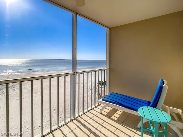 balcony with a water view and a beach view