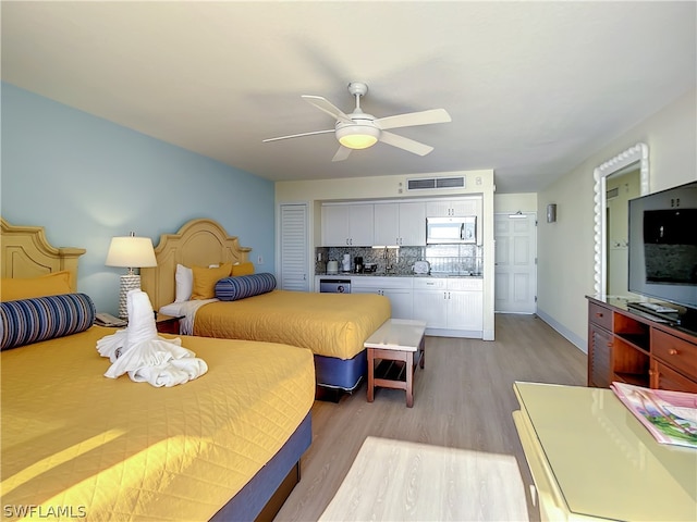 bedroom featuring light hardwood / wood-style flooring and ceiling fan