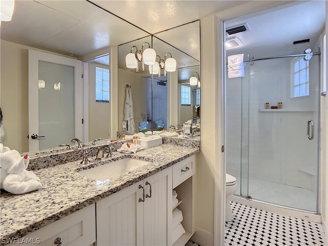 bathroom with vanity, tile patterned flooring, toilet, a wealth of natural light, and an enclosed shower