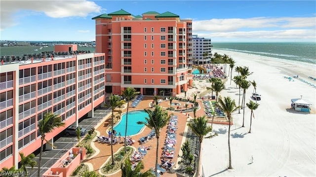 exterior space featuring a water view and a beach view