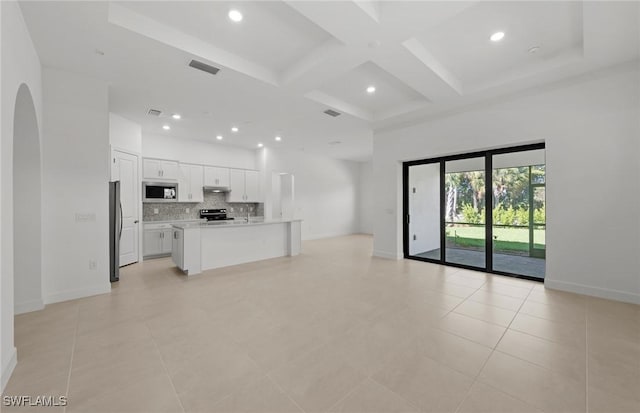 17161 Oakstead Dr, Alva, FL 33920 - unfurnished living room featuring baseboards, visible vents, a high ceiling, and coffered ceiling