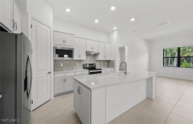 17161 Oakstead Dr, Alva, FL 33920 - kitchen with appliances with stainless steel finishes, under cabinet range hood, a sink, backsplash, and light tile patterned floors
