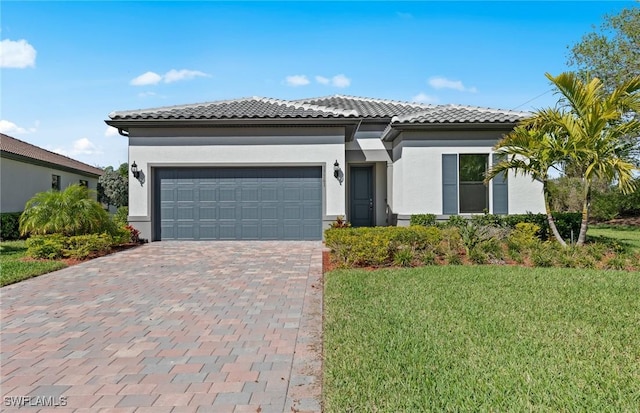 17161 Oakstead Dr, Alva, FL 33920 - view of front of home featuring driveway, stucco siding, an attached garage, and a tiled roof