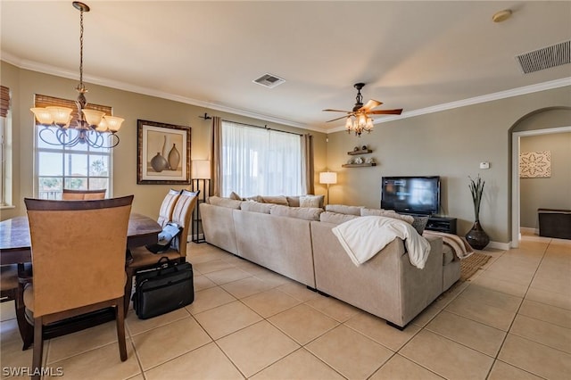 living room featuring ornamental molding, ceiling fan with notable chandelier, and light tile patterned floors