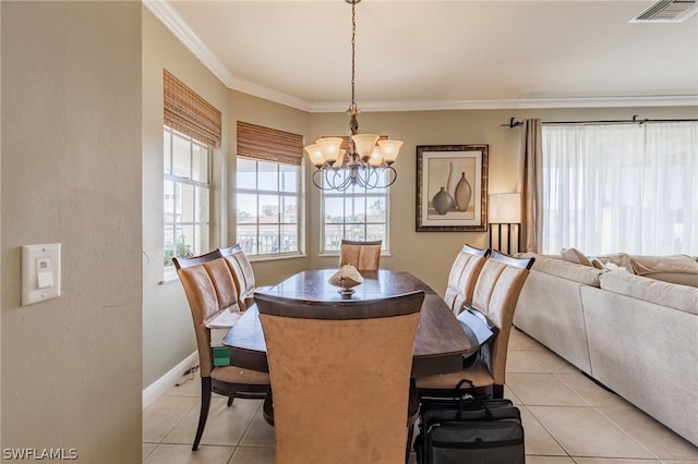 dining space featuring ornamental molding, light tile patterned floors, and an inviting chandelier