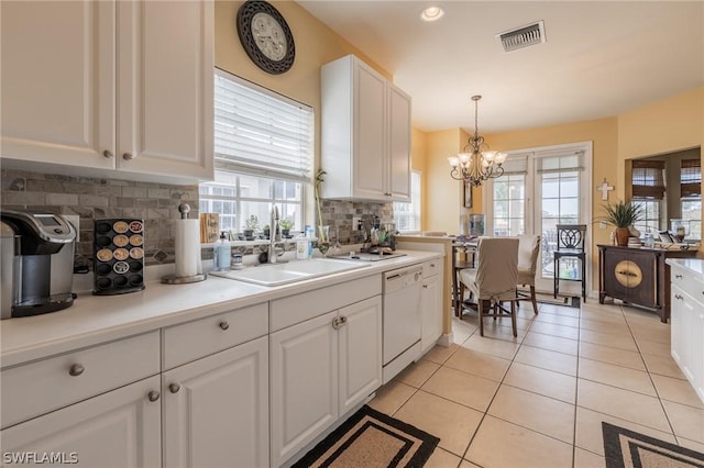 kitchen featuring white cabinetry, white dishwasher, tasteful backsplash, and pendant lighting