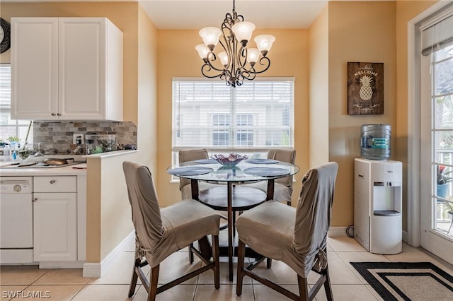 tiled dining space featuring a notable chandelier