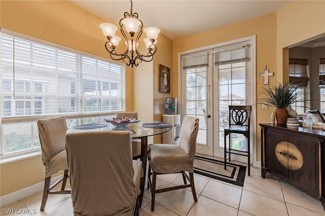 tiled dining area with an inviting chandelier and french doors