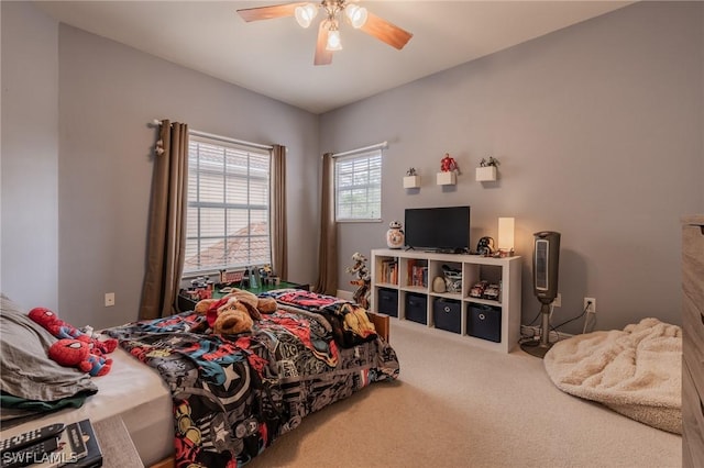 bedroom featuring ceiling fan and carpet