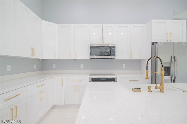 kitchen featuring white cabinets, appliances with stainless steel finishes, and sink