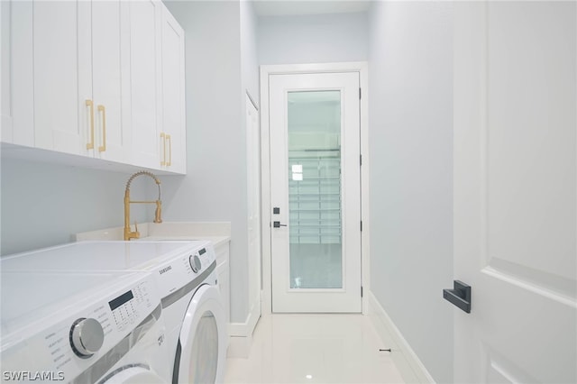 clothes washing area with sink, cabinets, washer and clothes dryer, and light tile patterned floors