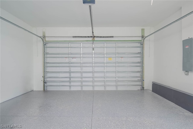 garage with a garage door opener and electric panel