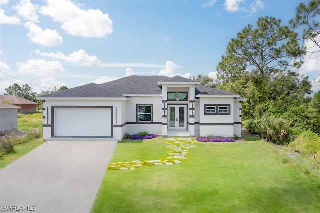 prairie-style home with french doors, a garage, and a front yard