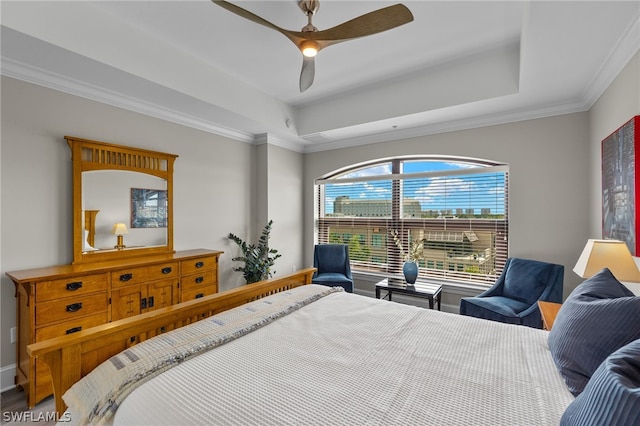 bedroom featuring ornamental molding, a raised ceiling, and ceiling fan