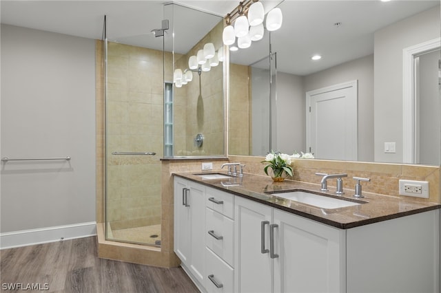 bathroom with wood-type flooring, an enclosed shower, and vanity