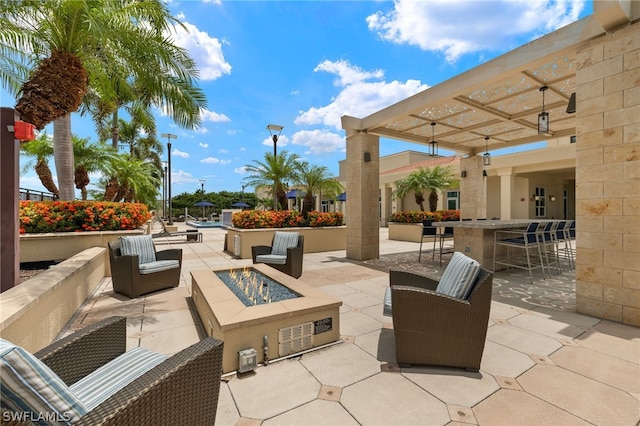 view of patio / terrace with a bar and a fire pit